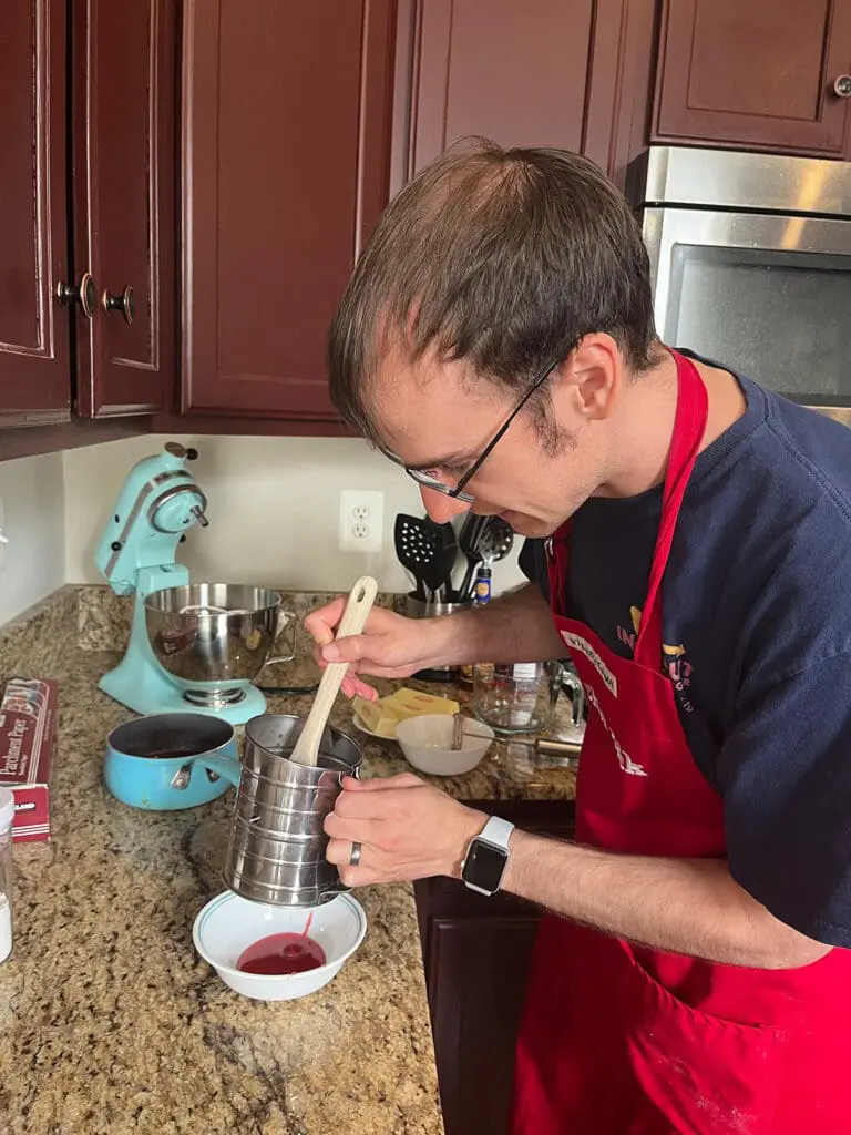 Passing the raspberry jam through a sifter