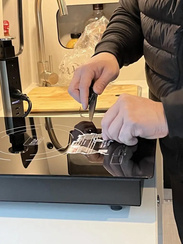 RV removing sticker from the stove