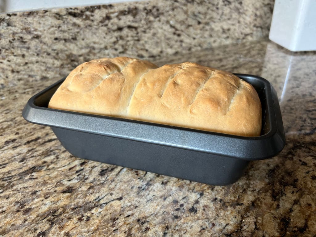 Homemade sandwich bread resting in baking pan