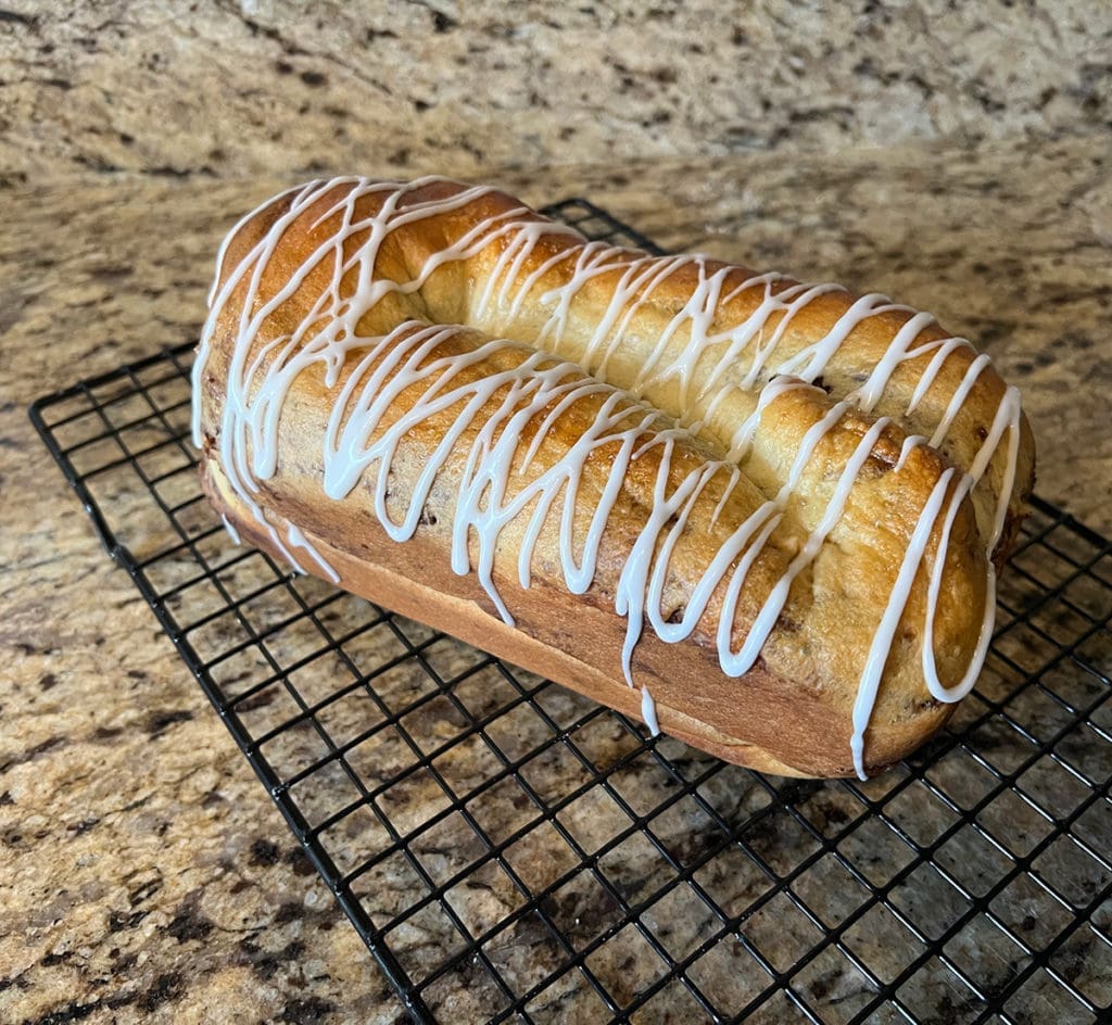 Iced povitica loaf sitting on wire rack