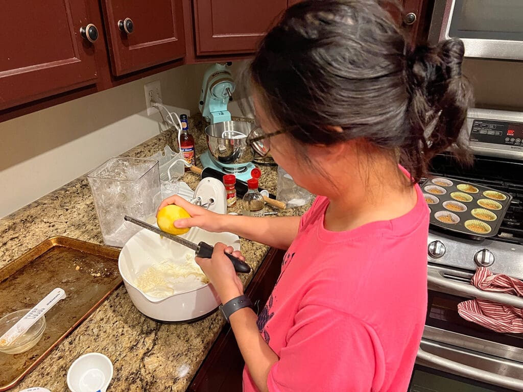 Adding lemon zest to the mini cheesecake filling