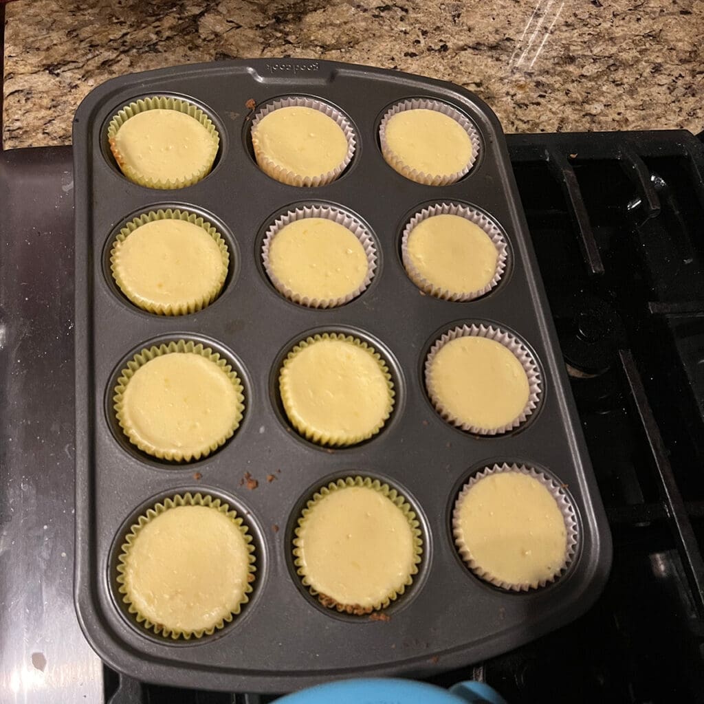 Mini Cheesecakes with filling chilling on stove