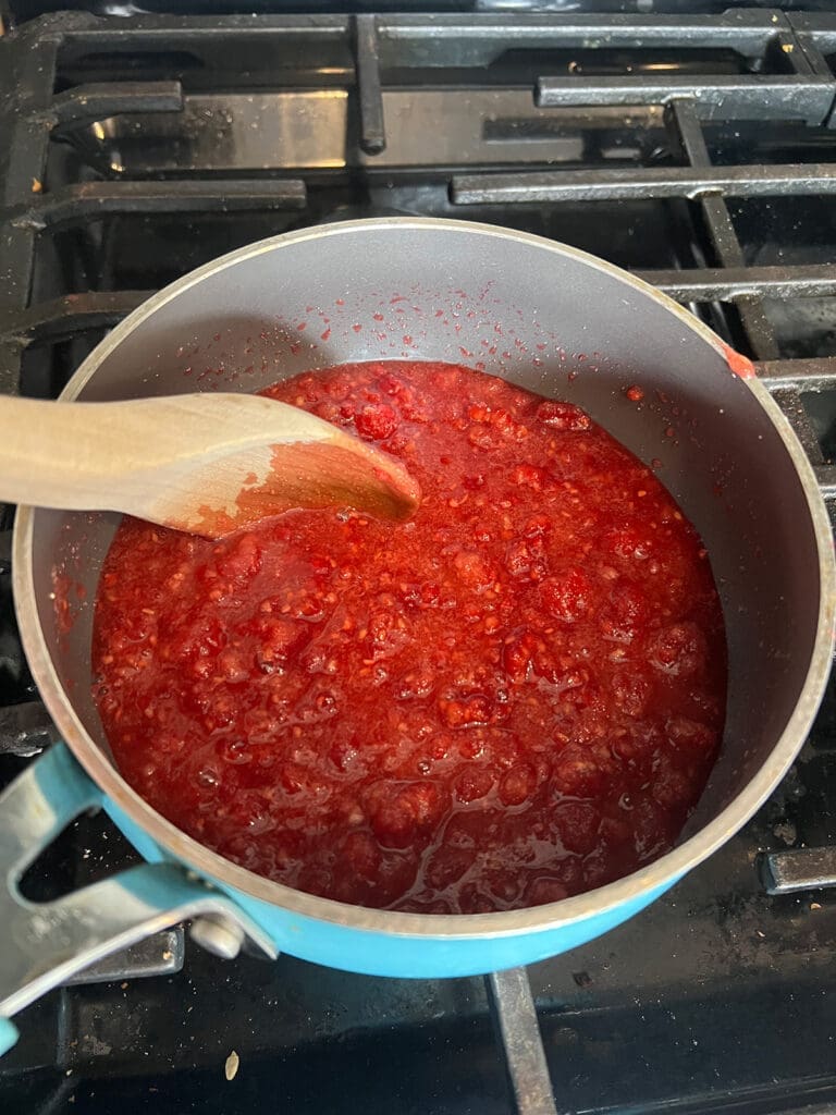 Raspberry Jam stirring on the stove