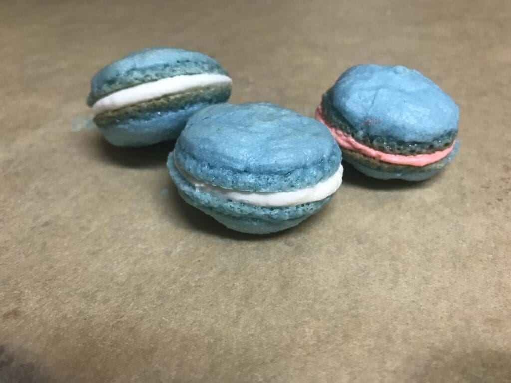 blue macarons with white and pink filling